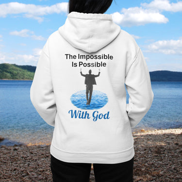 Gildan unisex zip-up hoodie with “Impossible Man” design featuring a man walking on water and uplifting message, Christian apparel made from soft cotton-poly fleece, perfect for cold weather and spiritual encouragement, woman in white hoodie